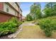 A lush backyard with green grass and a stone walkway leading to a cozy patio area at 4960 Tadmore Ln, Lithonia, GA 30038