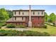 Spacious backyard with a well-maintained lawn, stone patio, and mature trees for privacy at 4960 Tadmore Ln, Lithonia, GA 30038