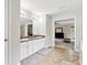Bright bathroom features dual sinks, granite countertops, and tile flooring, with an adjacent living space at 4960 Tadmore Ln, Lithonia, GA 30038