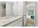 Bathroom with a double vanity sink, mirror and an adjacent bedroom at 4960 Tadmore Ln, Lithonia, GA 30038