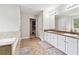 Dual vanity bathroom featuring lots of countertop space, a separate tub, and ample natural light at 4960 Tadmore Ln, Lithonia, GA 30038