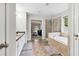 Well-lit bathroom with tub and shower, plus an open view into a carpeted living space at 4960 Tadmore Ln, Lithonia, GA 30038