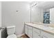 Bright bathroom featuring double sinks, large mirror, and a shower with colorful curtains at 4960 Tadmore Ln, Lithonia, GA 30038
