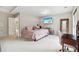 A spacious bedroom with soft carpet, a mounted TV, and a private entrance to an outdoor deck at 4960 Tadmore Ln, Lithonia, GA 30038