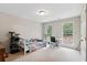 Well-lit bedroom with two windows, a plush bed, and a dedicated workspace area at 4960 Tadmore Ln, Lithonia, GA 30038