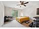 Bright bedroom with a ceiling fan, neutral walls, and a large window for ample natural light at 4960 Tadmore Ln, Lithonia, GA 30038