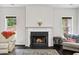 Close-up of a living room fireplace featuring a decorative mantel and flanked by bright, natural light at 4960 Tadmore Ln, Lithonia, GA 30038