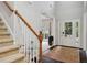 Bright foyer showcasing a staircase, elegant entry door with sidelights, and hardwood flooring at 4960 Tadmore Ln, Lithonia, GA 30038