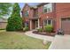 Charming brick home featuring lush landscaping, a curved walkway, and a welcoming front entrance at 4960 Tadmore Ln, Lithonia, GA 30038