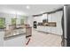 Open kitchen with white cabinets, stainless steel appliances, and tile flooring at 4960 Tadmore Ln, Lithonia, GA 30038