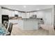Kitchen with a large island and white cabinets, open to the dining area at 4960 Tadmore Ln, Lithonia, GA 30038