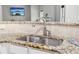 Close-up of kitchen sink with granite countertop and tile backsplash at 4960 Tadmore Ln, Lithonia, GA 30038