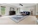 Inviting living room features neutral walls and carpet, along with large windows that flood the space with natural light at 4960 Tadmore Ln, Lithonia, GA 30038