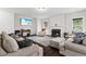 Comfortable living room featuring ample seating, a fireplace, and large TV, perfect for relaxation at 4960 Tadmore Ln, Lithonia, GA 30038