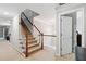 Carpeted staircase with white railings, bright lighting, and a view of the upper level at 4960 Tadmore Ln, Lithonia, GA 30038