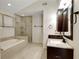 Luxurious bathroom featuring a soaking tub, walk-in shower with glass doors, and a modern vanity at 5320 Taylor Rd, Alpharetta, GA 30022