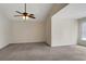 Spacious bedroom featuring a vaulted ceiling, a ceiling fan, plush carpeting, and neutral paint at 5320 Taylor Rd, Alpharetta, GA 30022