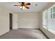 Spacious bedroom with carpet, ceiling fan, and natural light from the window at 5320 Taylor Rd, Alpharetta, GA 30022