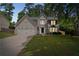 Charming two-story home with a well-manicured lawn and attached two-car garage, creating a welcoming curb appeal at 5320 Taylor Rd, Alpharetta, GA 30022