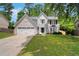 Charming two-story home with a well-manicured lawn and attached two-car garage, creating a welcoming curb appeal at 5320 Taylor Rd, Alpharetta, GA 30022