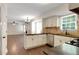 Bright kitchen with stainless appliances, tiled backsplash, and hardwood floors at 5320 Taylor Rd, Alpharetta, GA 30022