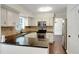 Inviting kitchen with stainless appliances, tiled backsplash, and dark countertops at 5320 Taylor Rd, Alpharetta, GA 30022