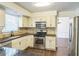 Cozy kitchen with stainless appliances, tiled backsplash, and dark countertops at 5320 Taylor Rd, Alpharetta, GA 30022