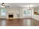 Open-concept living area boasting natural light, fireplace, and hardwood floors at 5320 Taylor Rd, Alpharetta, GA 30022