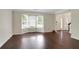 Inviting living room featuring a bay window that floods the room with natural light and gleaming hardwood floors at 5320 Taylor Rd, Alpharetta, GA 30022