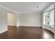 Open living room with hardwood floors, large bay window, and access to adjacent rooms, offering a spacious layout at 5320 Taylor Rd, Alpharetta, GA 30022