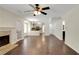 Spacious living room with hardwood floors, fireplace and views of the kitchen at 5320 Taylor Rd, Alpharetta, GA 30022