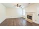 Living room with a decorative fireplace, ceiling fan, and hardwood flooring at 5320 Taylor Rd, Alpharetta, GA 30022