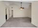 Bright living room with neutral paint, plush carpeting, a vaulted ceiling, and ceiling fan at 5320 Taylor Rd, Alpharetta, GA 30022