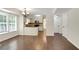Bright living room featuring hardwood floors, and adjacent kitchen with stainless steel appliances and ample counter space at 5320 Taylor Rd, Alpharetta, GA 30022