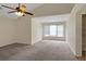 Spacious main bedroom with vaulted ceilings, a ceiling fan, large windows, and plush carpeting at 5320 Taylor Rd, Alpharetta, GA 30022