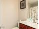 Clean bathroom featuring a single sink vanity with dark wood cabinets, framed art, and neutral walls at 2412 Wingfield Dr, Austell, GA 30106