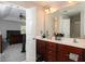 Primary bathroom featuring a double vanity, marble countertop, and a doorway leading to a bedroom at 2412 Wingfield Dr, Austell, GA 30106