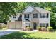 Inviting two-story house with brick accents, a two-car garage, and a green front lawn at 2412 Wingfield Dr, Austell, GA 30106