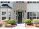 Close-up of front door with decorative wreath, sidelights, and manicured landscaping at 2412 Wingfield Dr, Austell, GA 30106