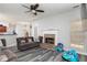 Spacious living room with gray wood-look floors, a brick fireplace, and a ceiling fan at 2412 Wingfield Dr, Austell, GA 30106