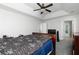 Bright main bedroom featuring tray ceiling, ceiling fan, carpeted floor, and access to en suite at 2412 Wingfield Dr, Austell, GA 30106