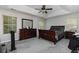 Spacious main bedroom featuring tray ceiling, ceiling fan, carpeted floor and dark wood furniture at 2412 Wingfield Dr, Austell, GA 30106