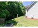 Lush side yard with a house exterior, lawn, trees, and natural surroundings at 2412 Wingfield Dr, Austell, GA 30106