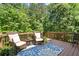 Inviting back deck with outdoor seating, perfect for enjoying the serene wooded views at 2660 Burnt Hickory Dr, Cumming, GA 30028