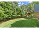 Expansive backyard with lush lawn and a wooden deck overlooking the scenic landscape at 2660 Burnt Hickory Dr, Cumming, GA 30028