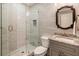 Bathroom with glass-door shower, marble wall tiles, granite countertop, and an ornate framed mirror at 2660 Burnt Hickory Dr, Cumming, GA 30028