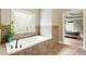 Main bathroom with large tub, window and view to main bedroom at 2660 Burnt Hickory Dr, Cumming, GA 30028