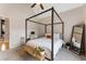 Sun-filled bedroom includes a four-poster bed, natural light, and neutral finishes for a relaxing ambiance at 2660 Burnt Hickory Dr, Cumming, GA 30028