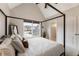 Cozy bedroom with a four-poster bed, large windows, and neutral paint, perfect for relaxation at 2660 Burnt Hickory Dr, Cumming, GA 30028