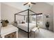 Bright bedroom features a four-poster bed, neutral decor, and large windows for plenty of natural light at 2660 Burnt Hickory Dr, Cumming, GA 30028